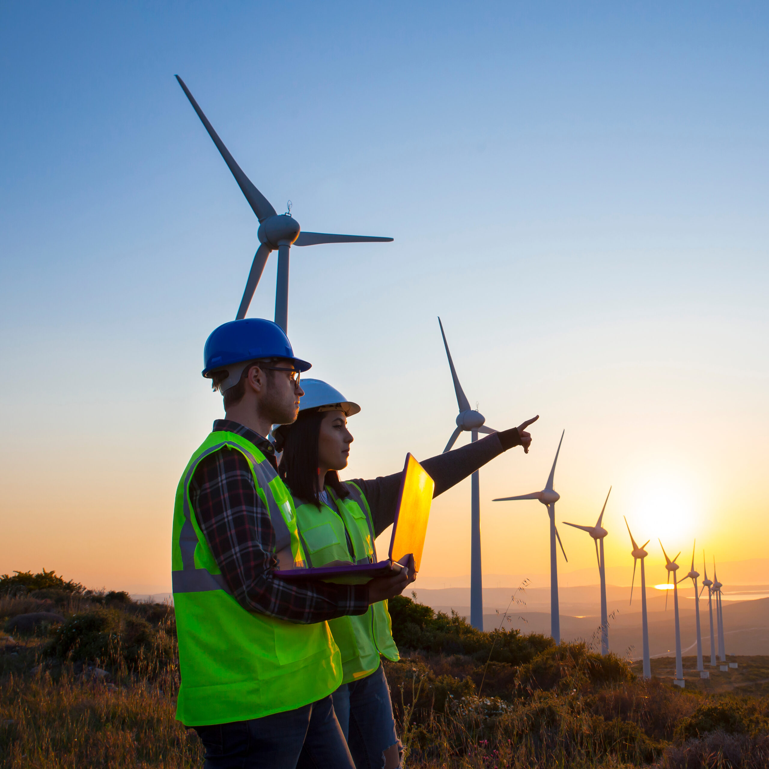 Young,Maintenance,Engineer,Team,Working,In,Wind,Turbine,Farm,At